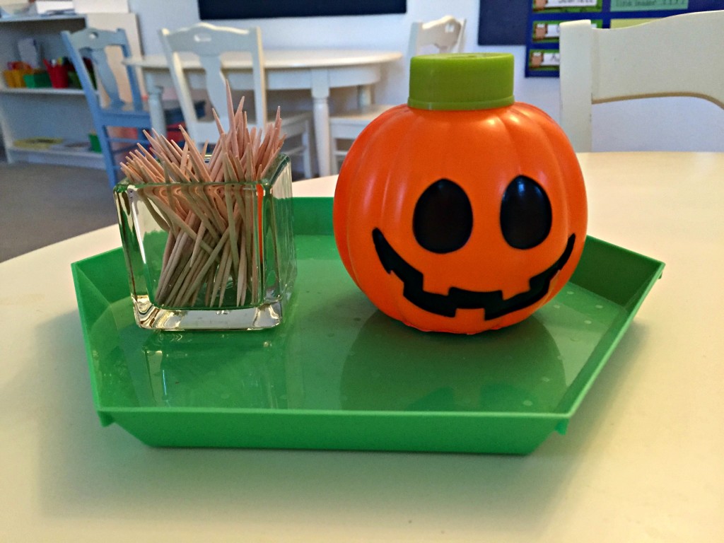 Halloween Practical Life Activity - Dropping toothpicks in a pumpkin container! 