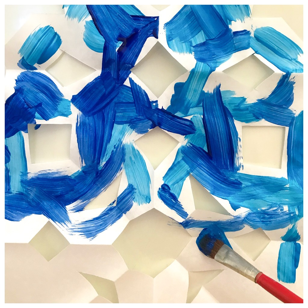 Painting Snowflakes at the Easel - Negative Space - Snowflake Activities in the Preschool Classroom 