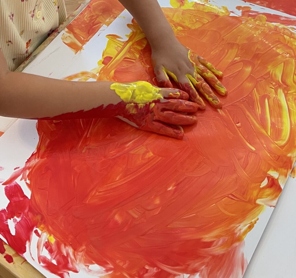 Color Mixing red and yellow paint 
